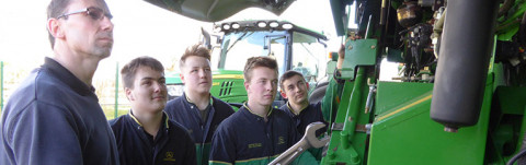 Richard Allard (left) Service Manager at Tallis Amos Group, talking through the basics of a combine harvester with apprentice technicians